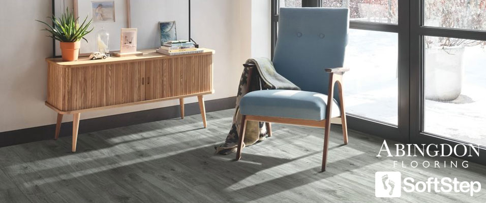 A blue-grey wood effect vinyl flooring that is in an open living area
